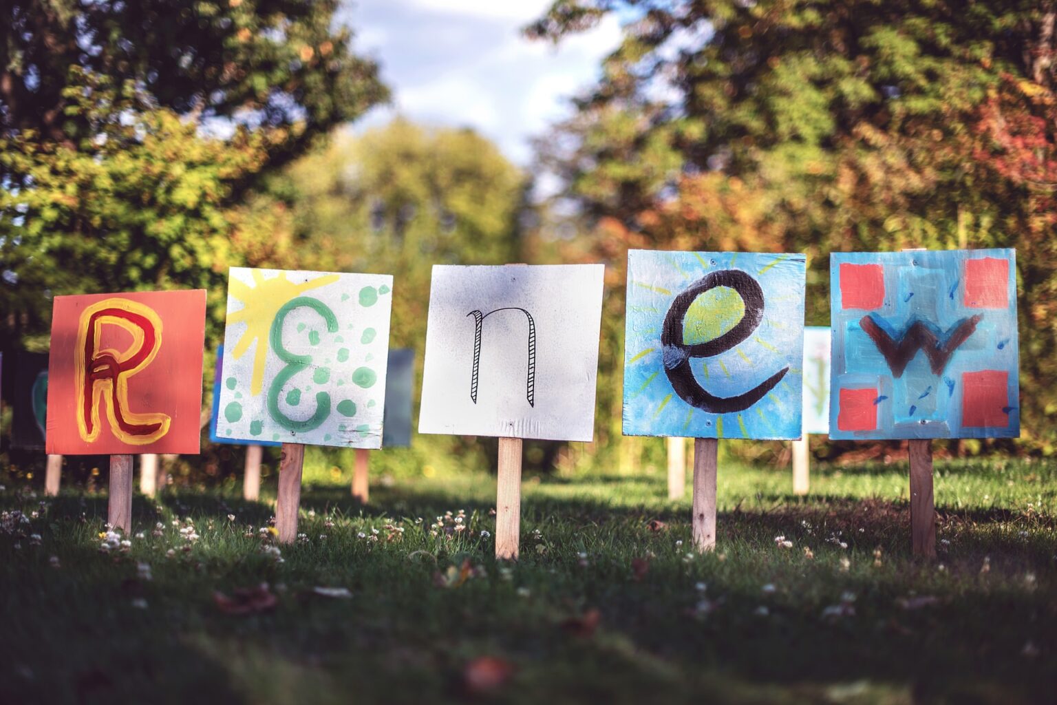 The word renew written on sign boards in a park. A symbolic way to say reduce event planning stress to renew yourself.