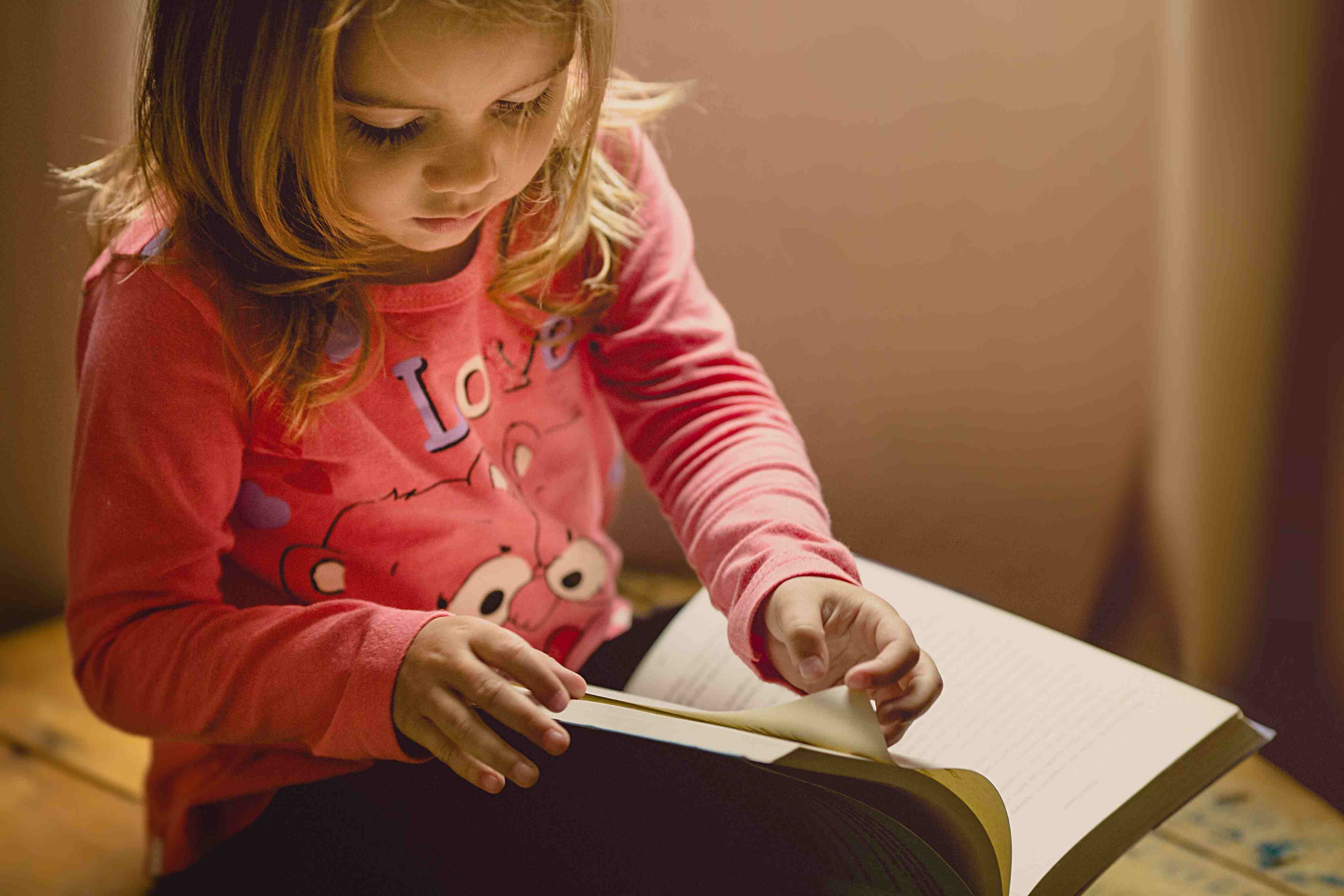 A kid reading a book