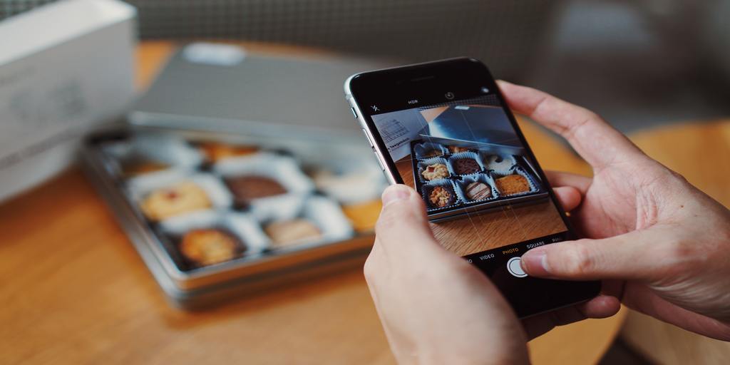 An influencer taking pictures of food