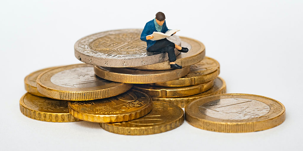 illustration of a cartoon man sitting on a stack of coins and reading a news paper