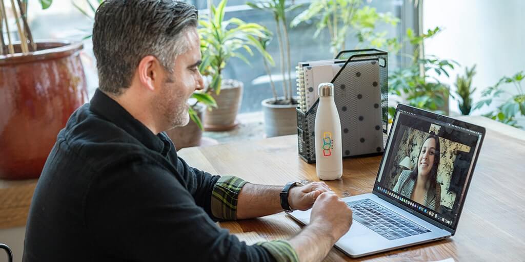 photo of a person speaking to another on a video call