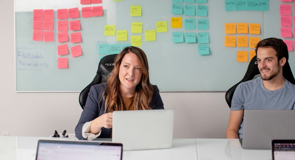 Two people talking to someone in a meeting room