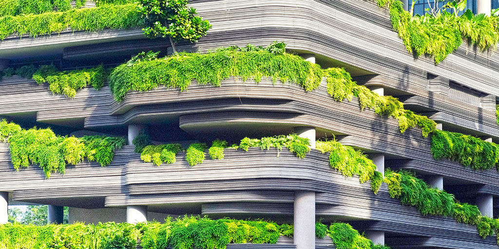 photo of a building with hanging plants on its facade