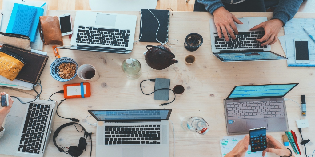 Few laptops are placed on the table. 