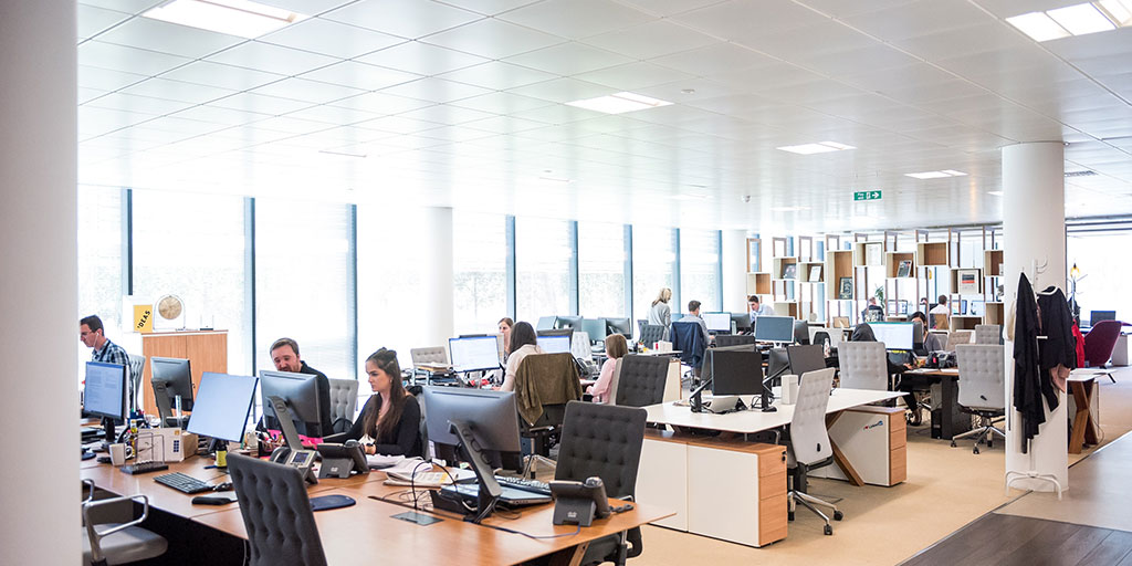 Photo of an open-plan office with people working at their desks