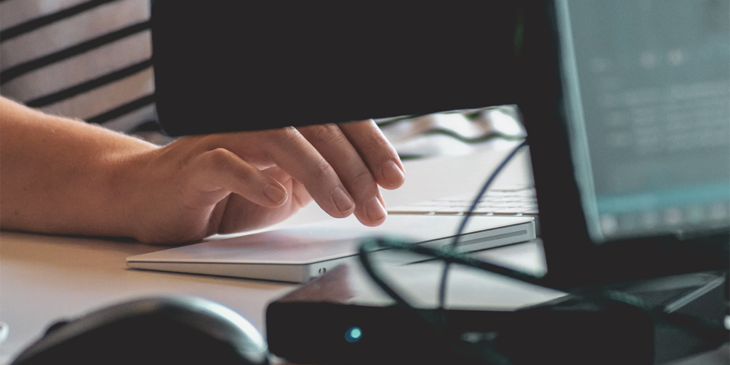 close up photo of a person's hand, taken while they're working on a computer