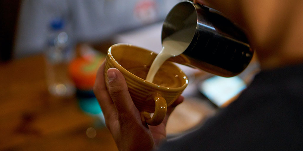 "barista pouring coffee"