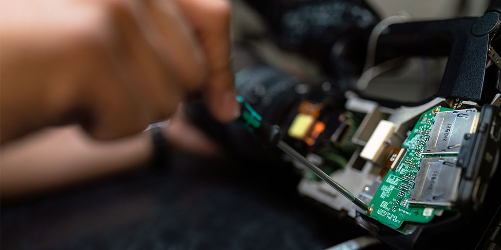 "technician working on a circuit board"